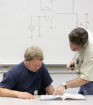 Image of people studying electronics