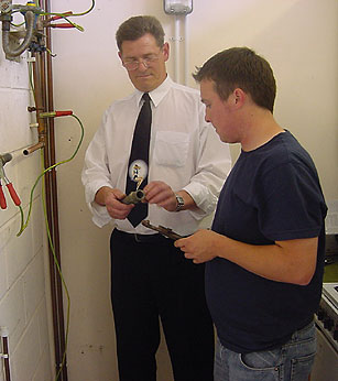 Image of people inspecting a pipe