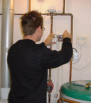 Image of a man checking electrics