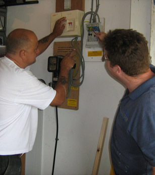 An image of two men checking some equipment