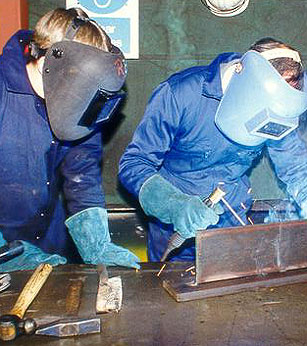 Image of two people welding