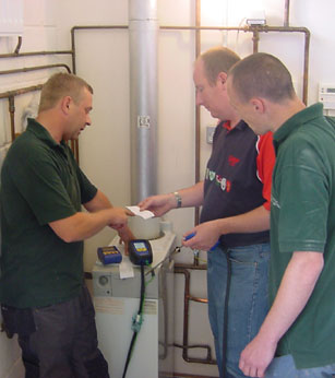 Image of three men testing equipment